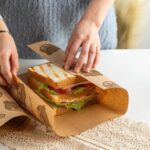 deli sandwich on printed sandwich wrap paper in café