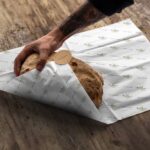 stack of printed food wrapping paper sheets for restaurant use